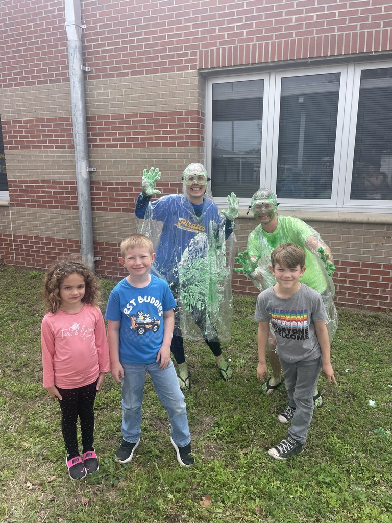 Dr. Weber and Ms. Trammell full of slime posing for a silly picture with the top 3 earning students for the American Heart Challenge.