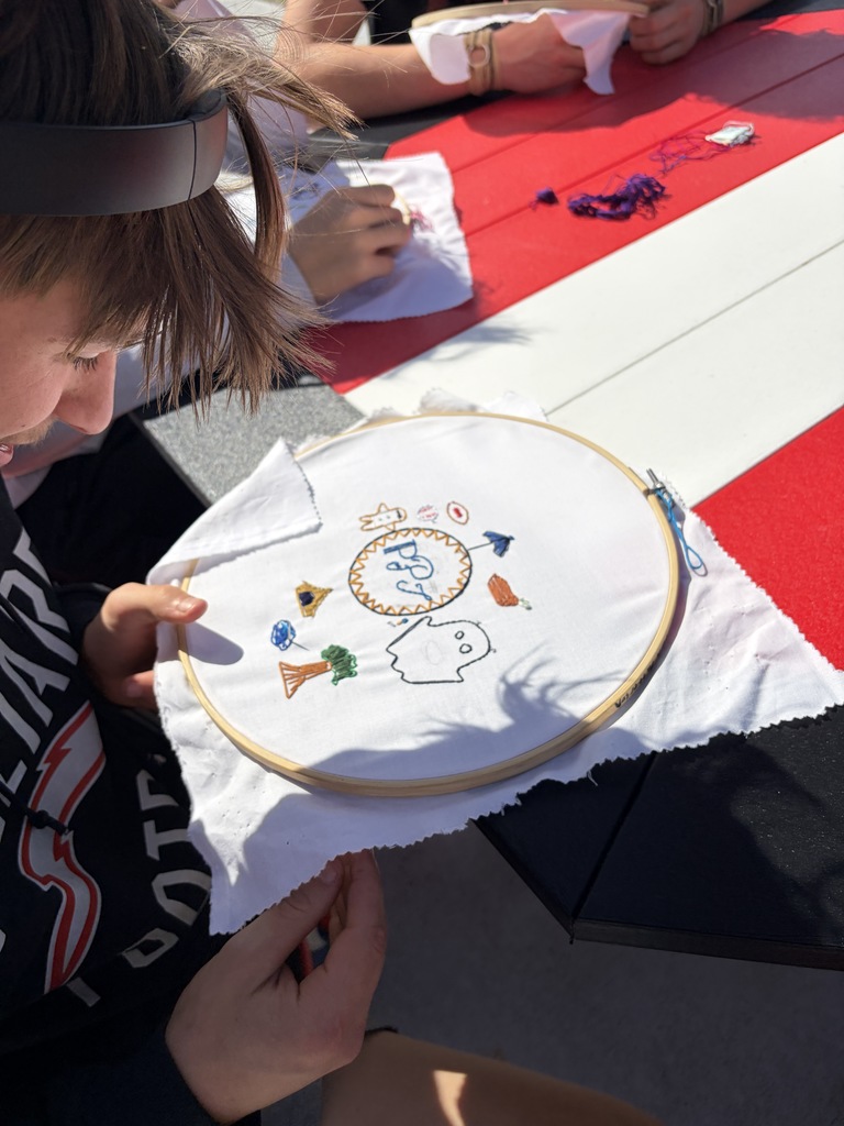 Student working on a hand embroidery memory project.