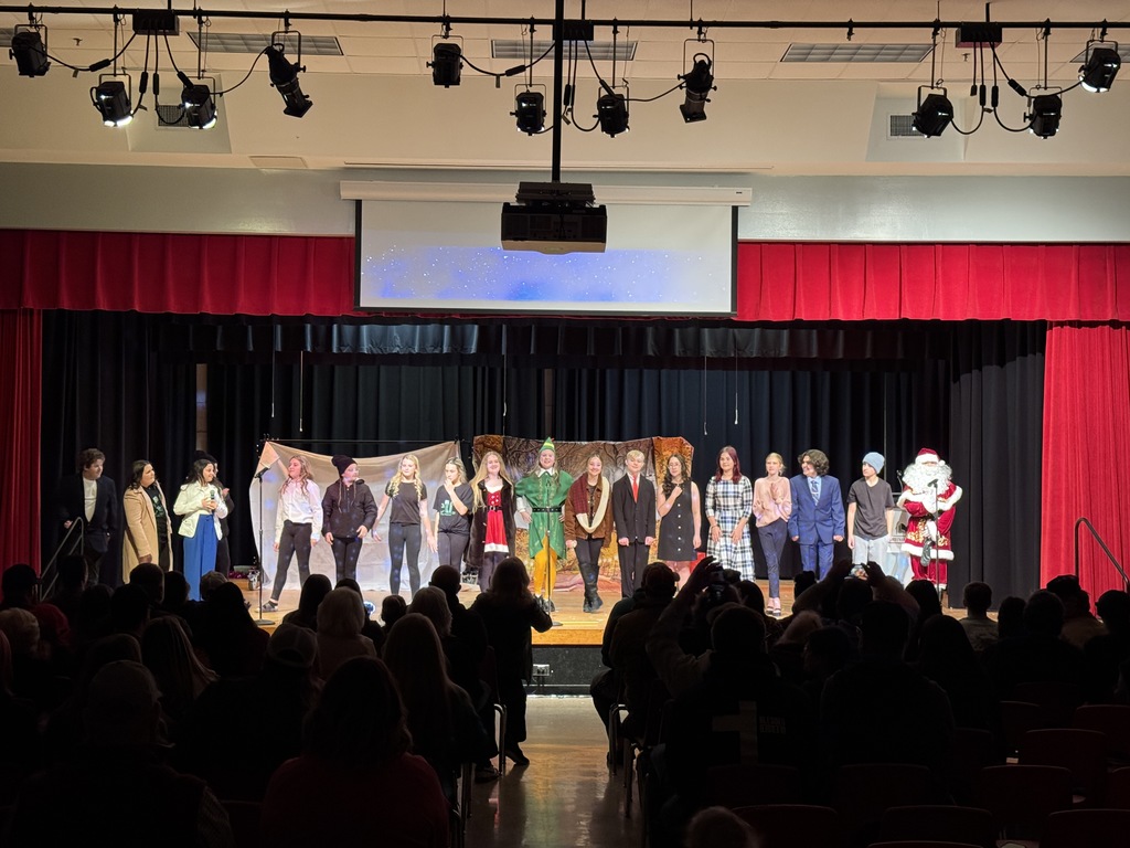 Cast members of Elf gather on stage at the closing scene.