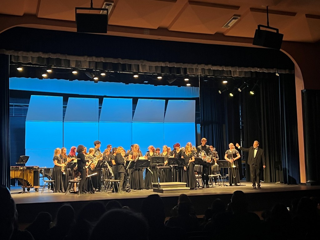 Band students on stage performing.