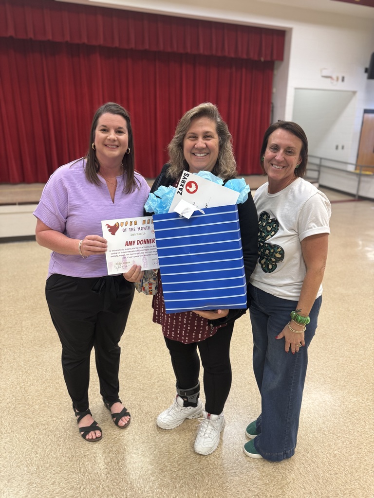 Principal & Assistant Principal of CES awarding Mrs. Donner with the January super hero of the month award!