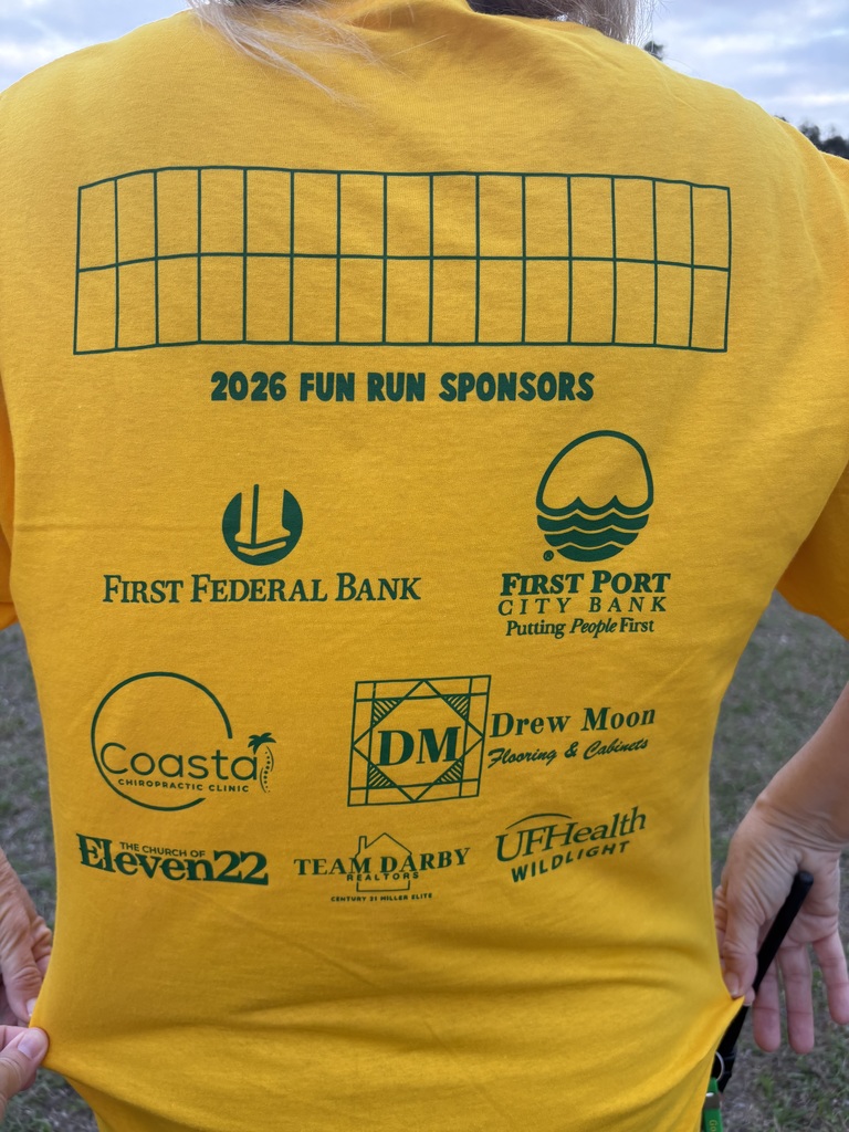 A close-up of a bright yellow 'Fun Run' sponsor sign listing local community partners and corporate donors who supported the school event