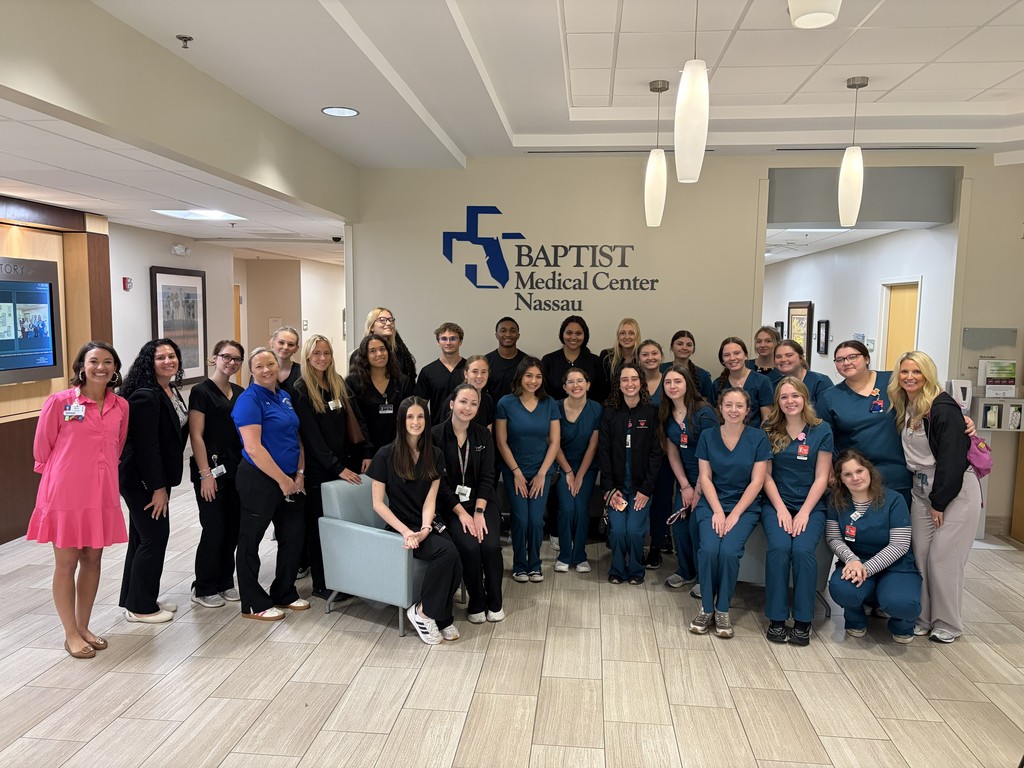 CNA students posing for photo with hospital staff.