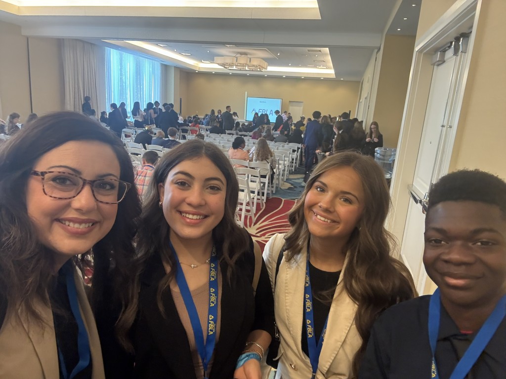 FBLA Students posing for photo with chaperone.