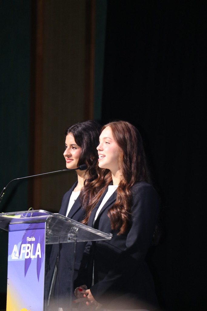Emma speaking on stage.