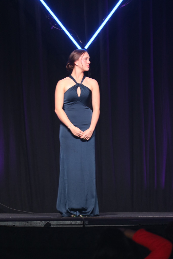 Emma posing for photo on stage.