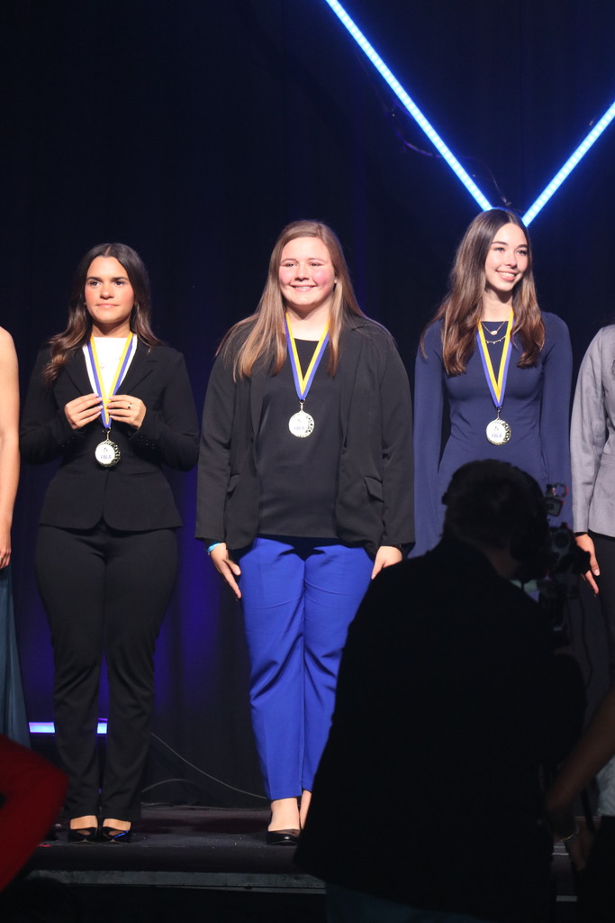 Student receiving award on stage.