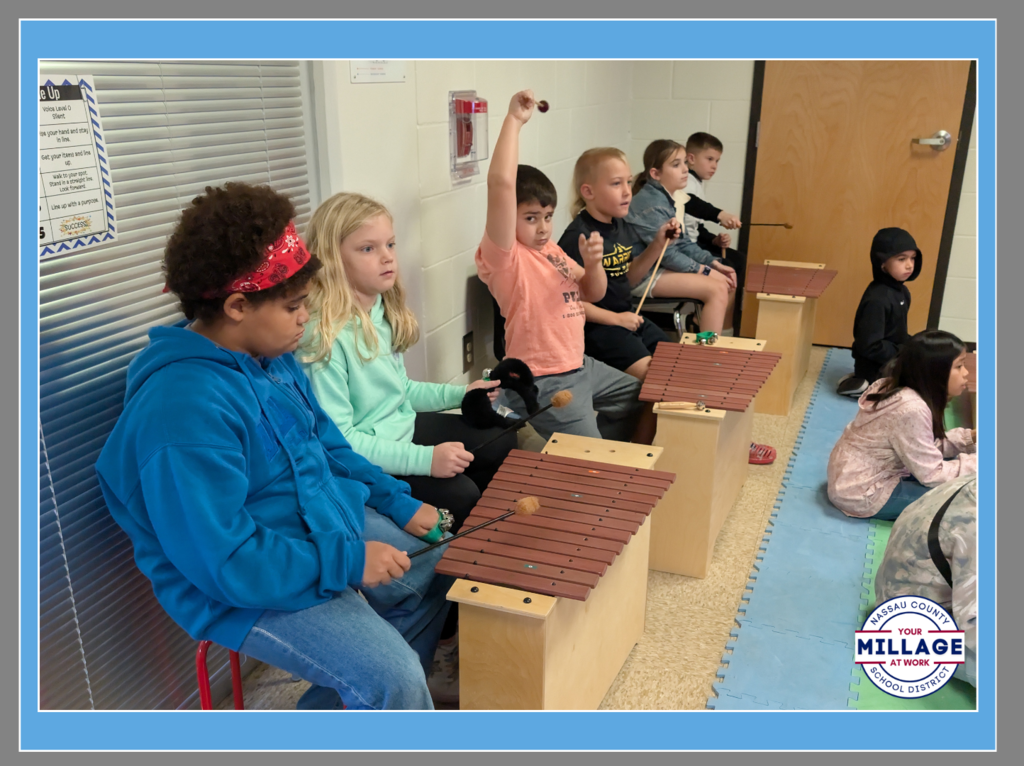 Students at Wildlight Elementary participating in a music lesson with xylophones and percussion instruments.