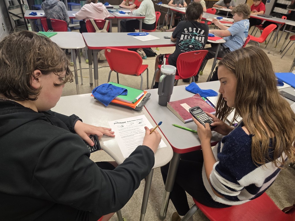 Students at desk working math calculations.