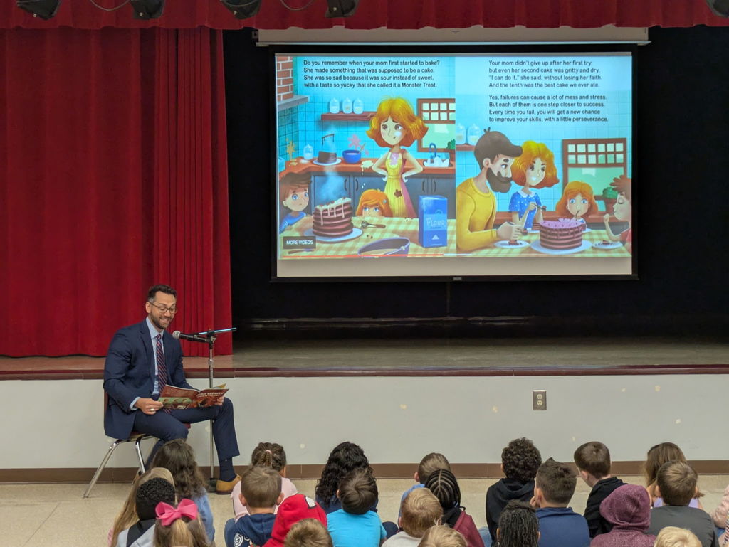 Mr. Cubbal reading to student group