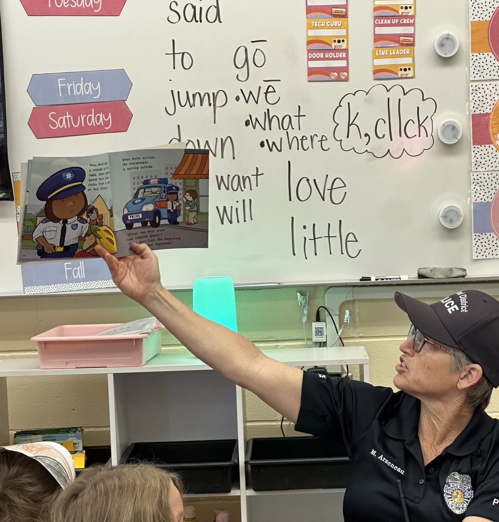 Officer Arseneau reading to student group