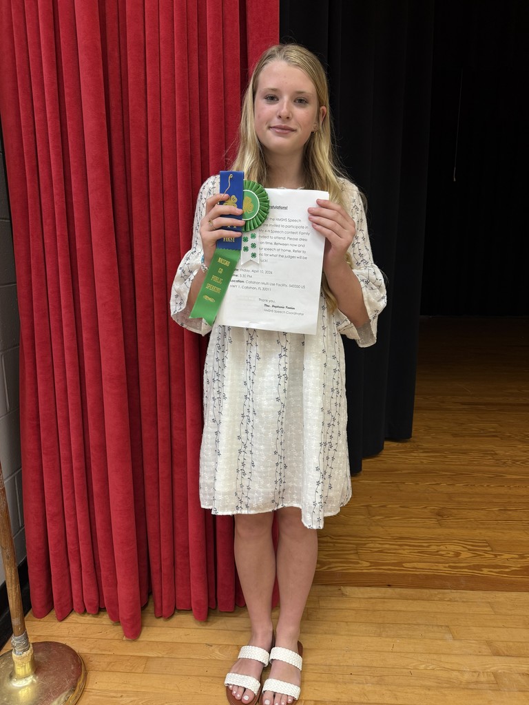 Student posing with award.