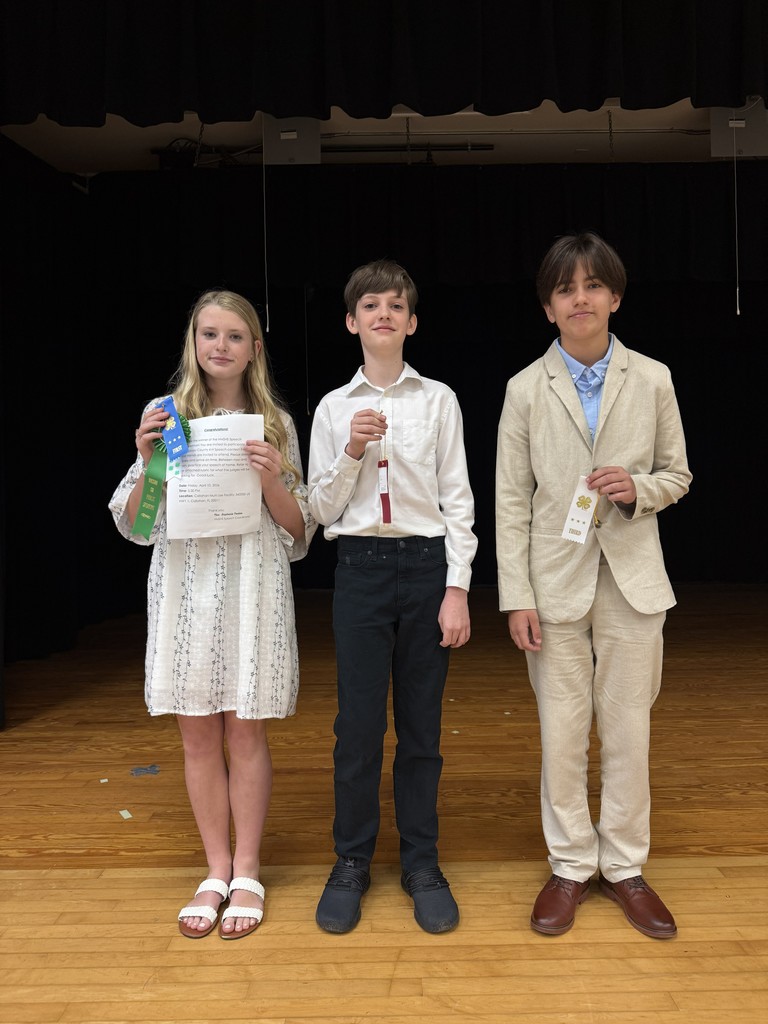 Student posing with award.