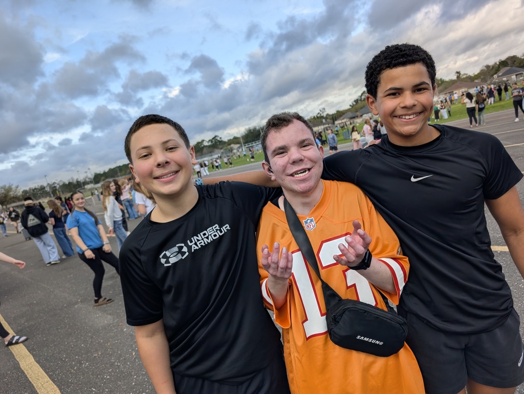 Three students pose for a picture smiling at infraction free day