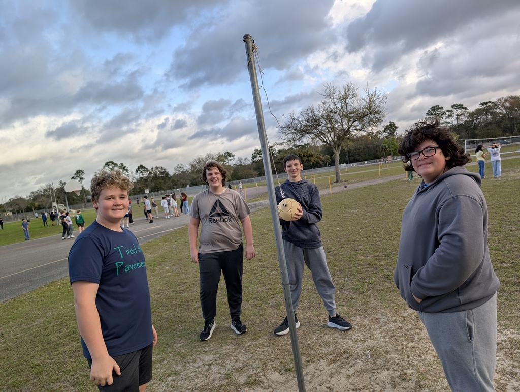 Four students pause their game of tetherball to smile for the camera at infraction free day at Yulee Middle School