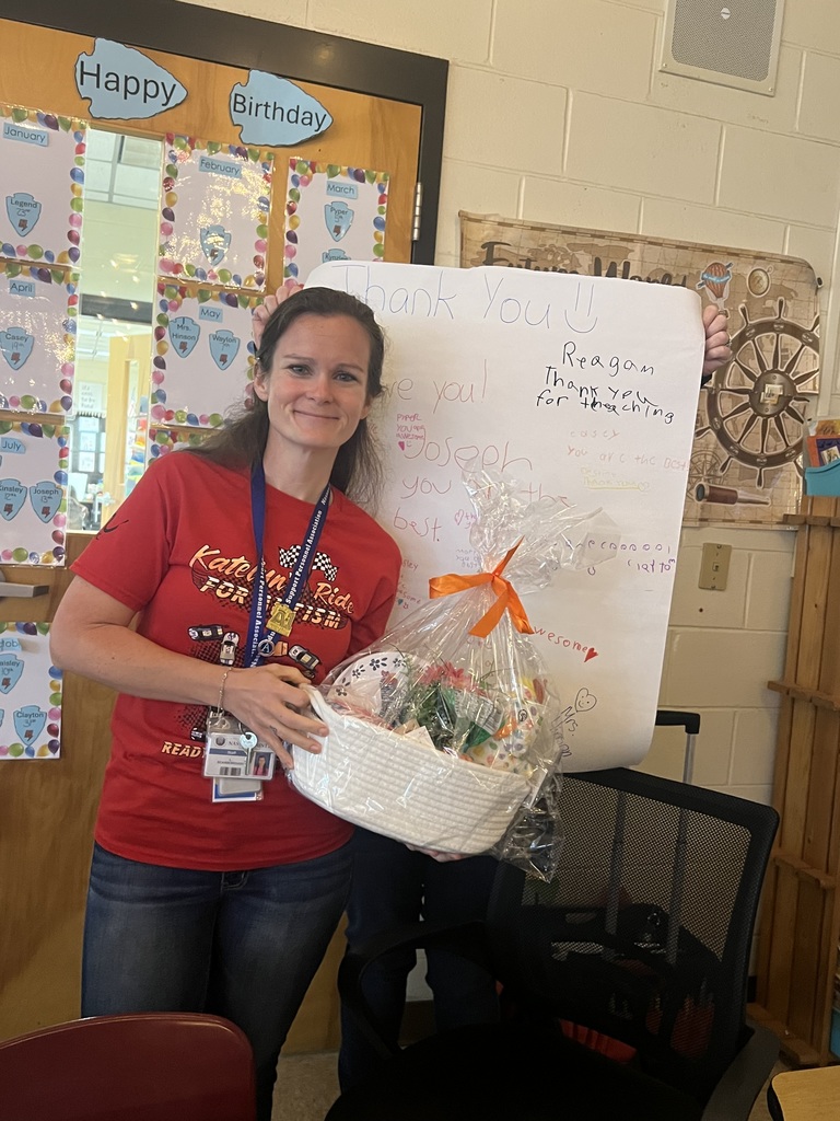Paraprofessional Mrs. Scarborough with a gift basket and notes of thanks from students
