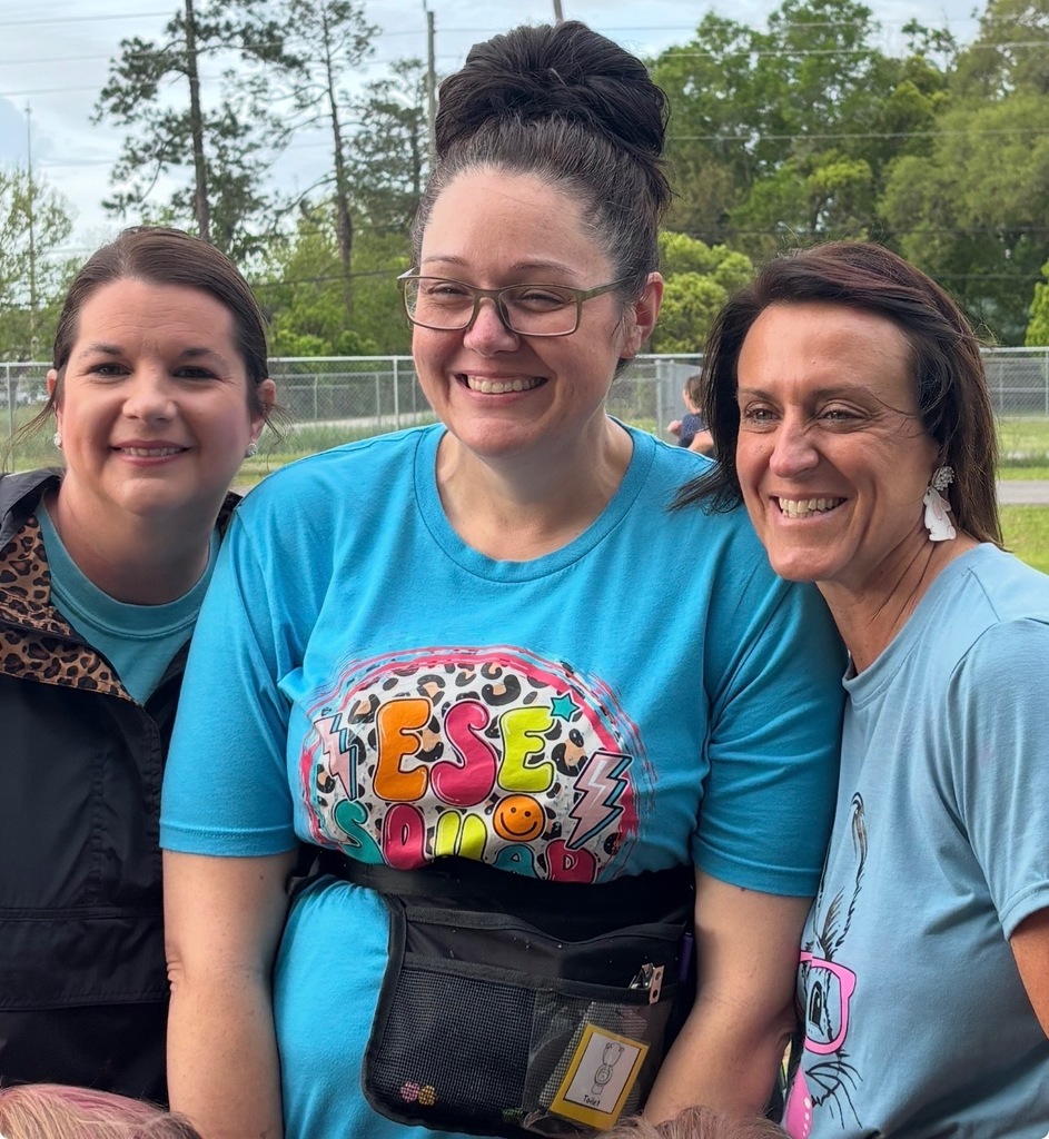 Mrs. Johnson, Mrs. Harper, & Mrs. Collins smiling for a photo.