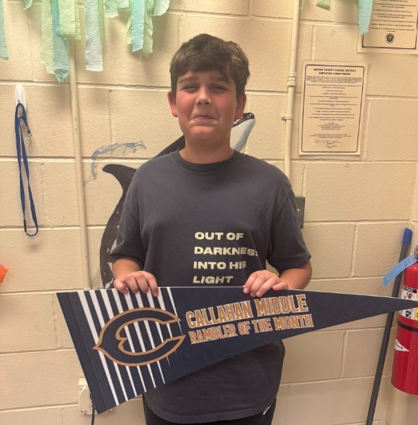 Photograph of student holding a Callahan Middle School pennant.