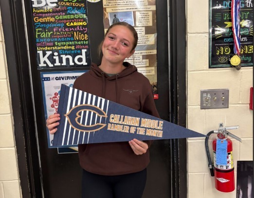 Photograph of student holding a Callahan Middle School pennant.
