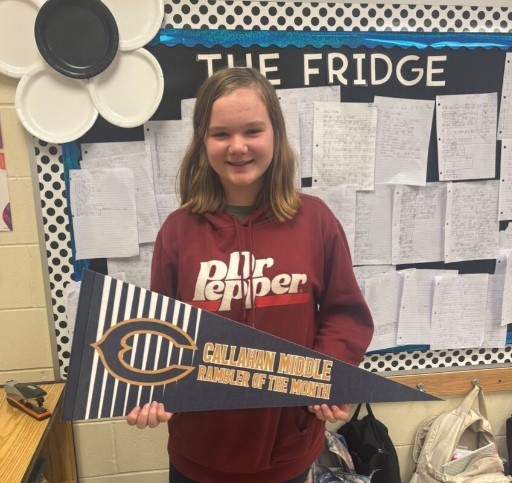 Photograph of student holding a Callahan Middle School pennant.