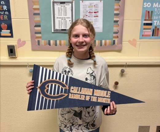 Photograph of student holding a Callahan Middle School pennant.