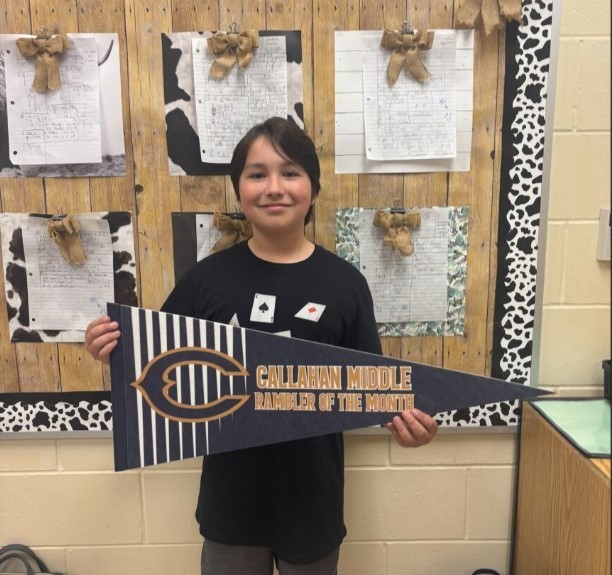 Photograph of student holding a Callahan Middle School pennant.