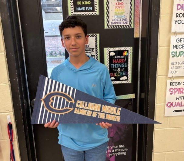 Photograph of student holding a Callahan Middle School pennant.