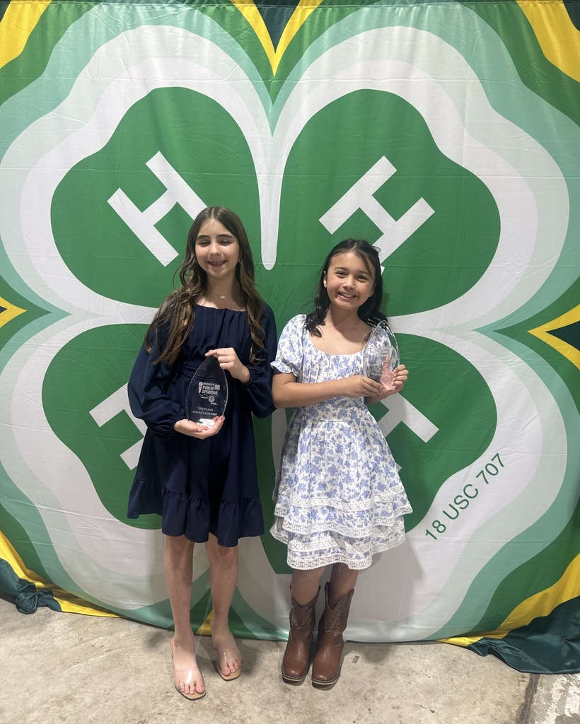 Two students holding their awards for the 4-h competition 