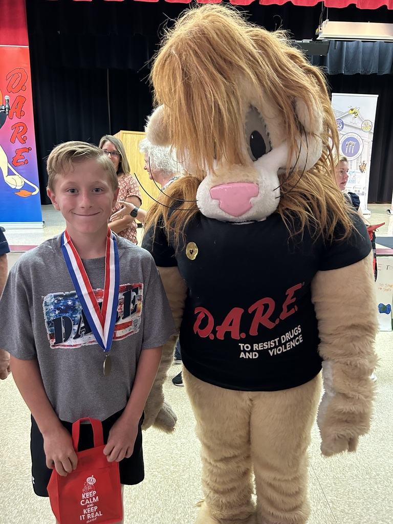 Darren the D.A.R.E. Lion with student 