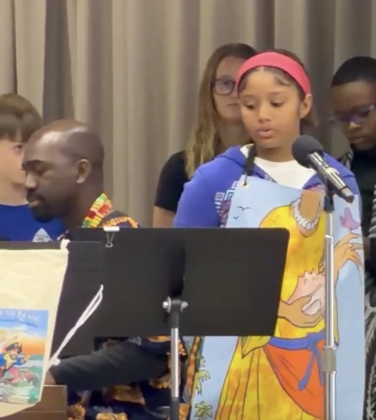 a man playing a piano and a young girl singing on stage  