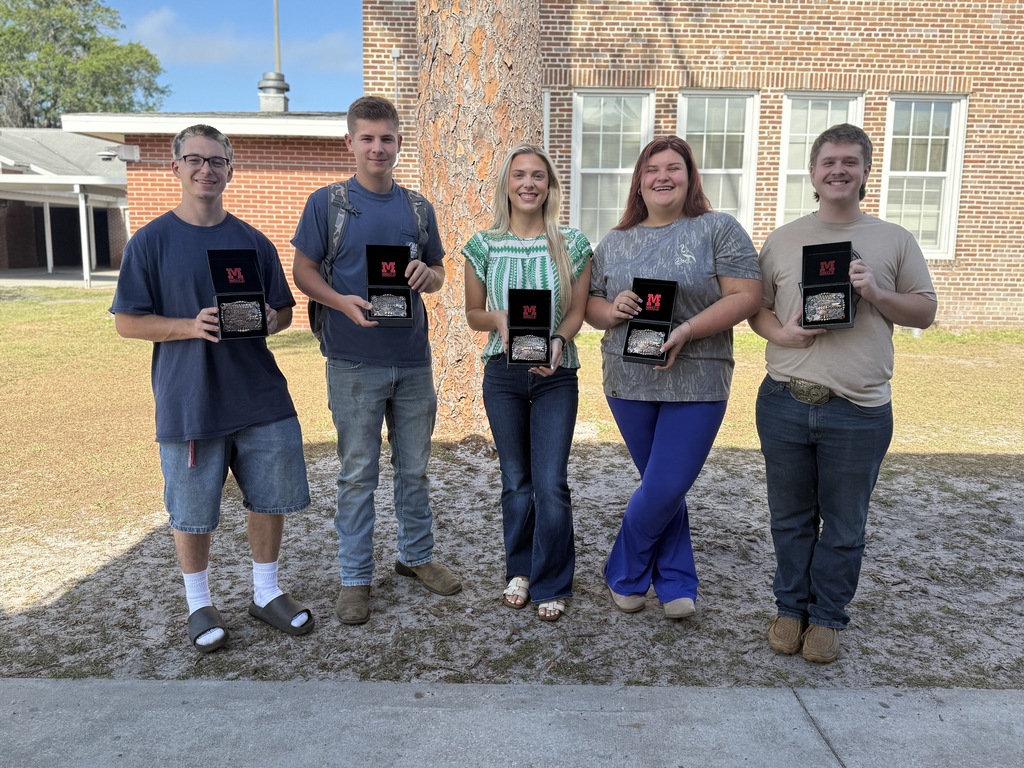 Seniors hold FFA belt buckles