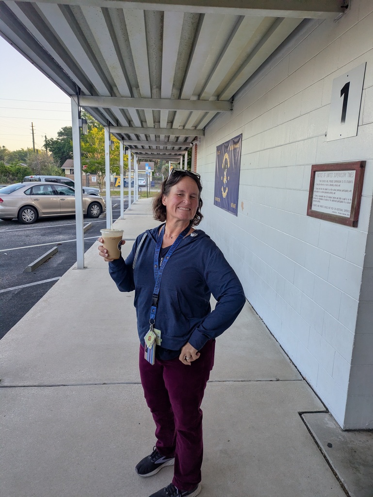 Ms. Allgood posing with her cup of coffee.