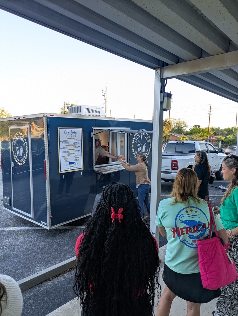 Line of teachers outside the coffee truck as one teacher receives her order.