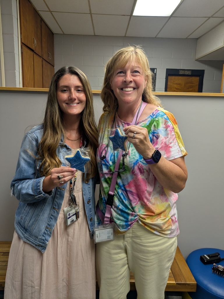 Ms. Woodley and Ms. Leary posing with their blue star shaped cookies.