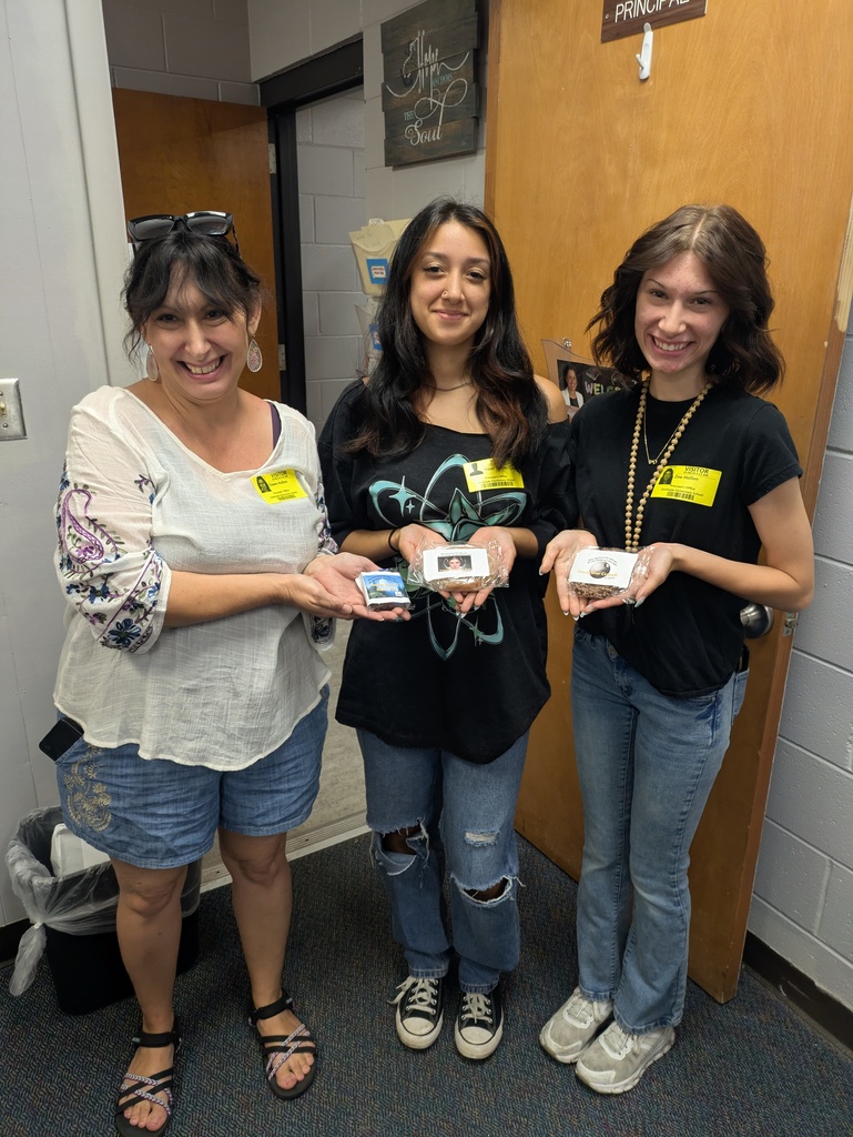 Three Christ walk, volunteers holding Sweet treats posing for picture