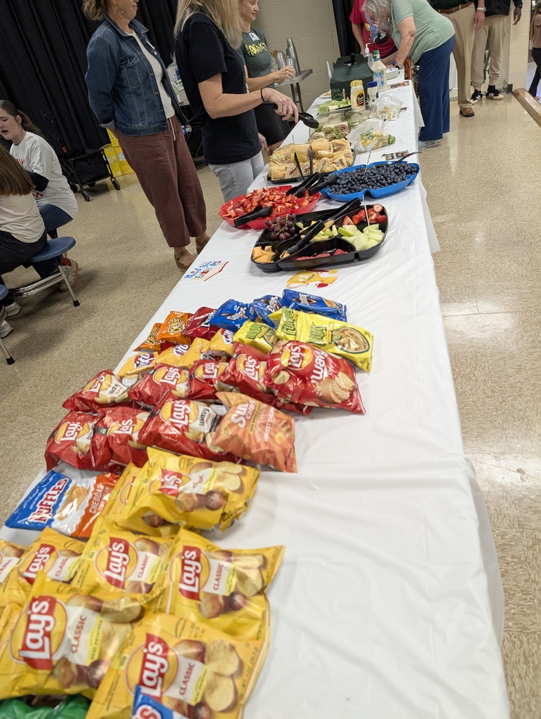 table shown with chips and fruit platters and sub sandwiches for teachers and staff. 