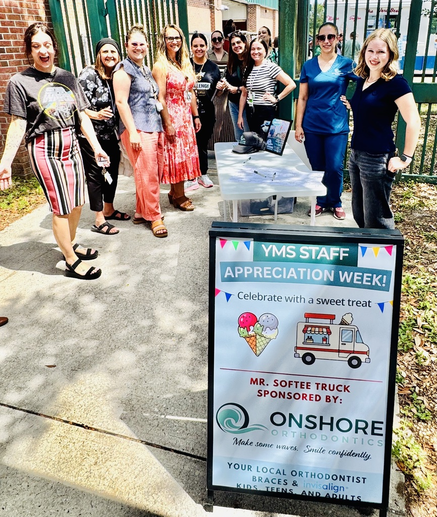 Staff at Yulee Middle School pose with big smiles behind the YMS STaff appreciation sign by Onshore as they await their treat from the Mr. Softee truck. 