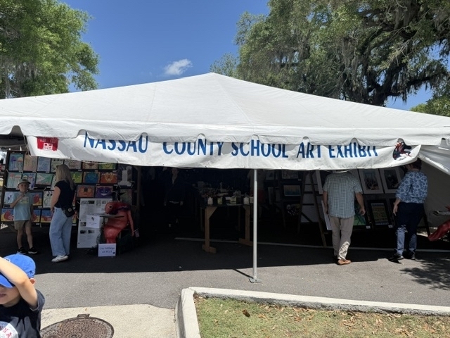 This photo shows a big white tent with a sign that read Nassau County School Art Exhibit that was put up during the Shrimp Festival.