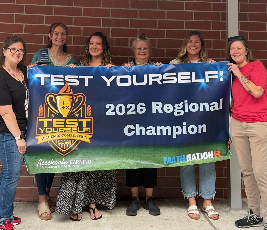 Math Teachers posing with 2026 Regional Champion Banner