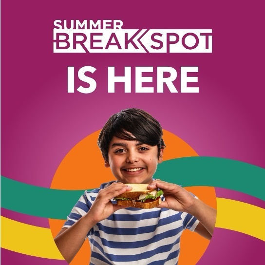 Child smiling while holding a sandwich in front of colorful Summer BreakSpot graphics. Text reads: “Summer BreakSpot is here.”