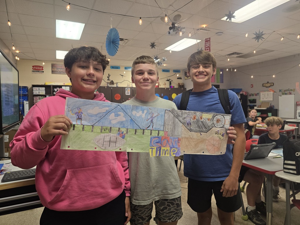 Students posing with roller coaster design.