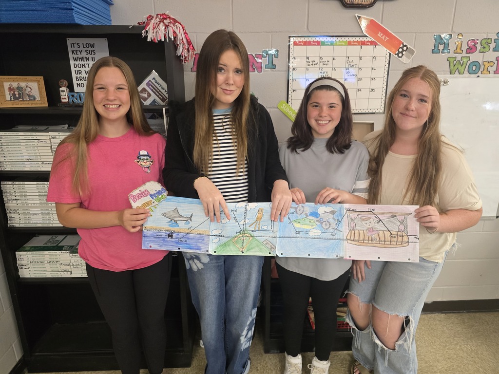Students posing with roller coaster design.