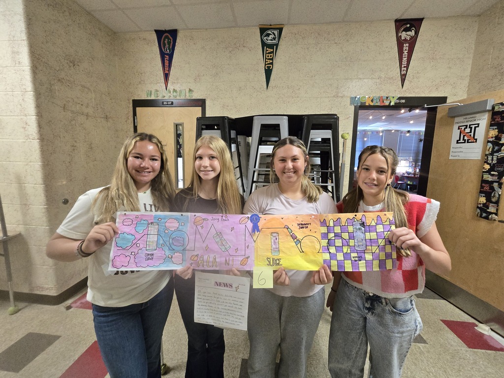 Students posing with roller coaster design.