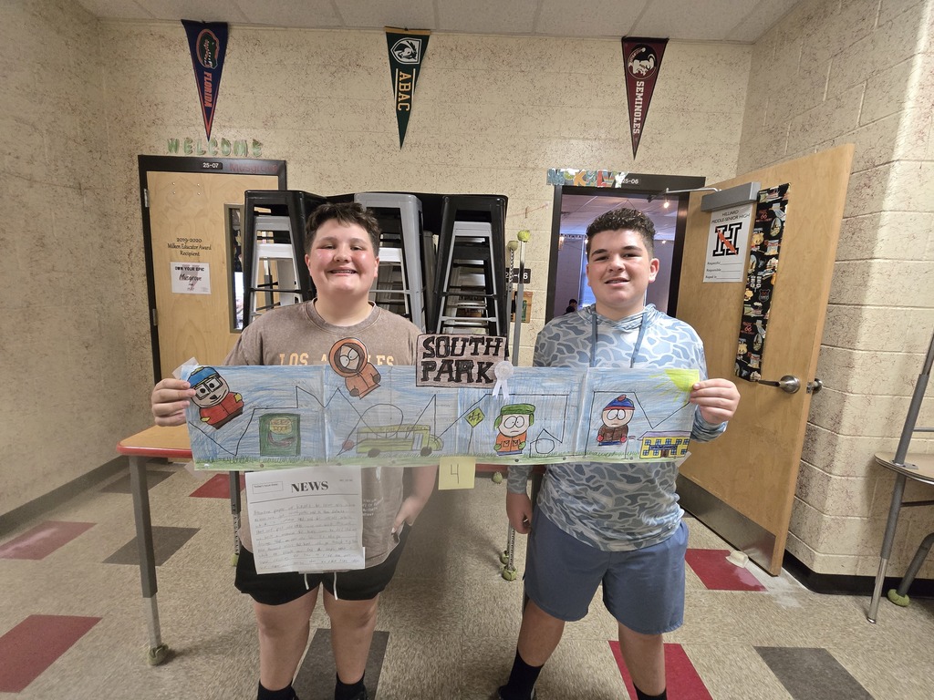 Students posing with roller coaster design.