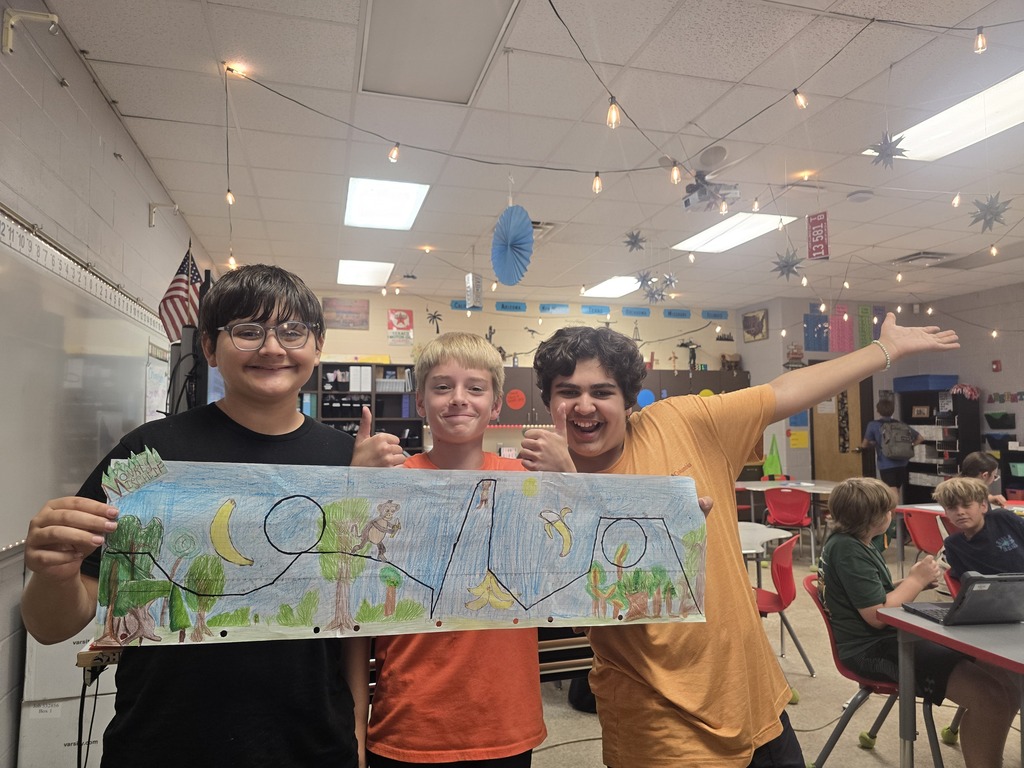 Students posing with roller coaster design.