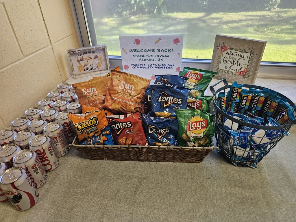 Donations for the Yulee Elementary staff lounge, including drinks, chips, and snack bars, displayed beneath a welcome-back sign thanking parents, families, and community members for their support.