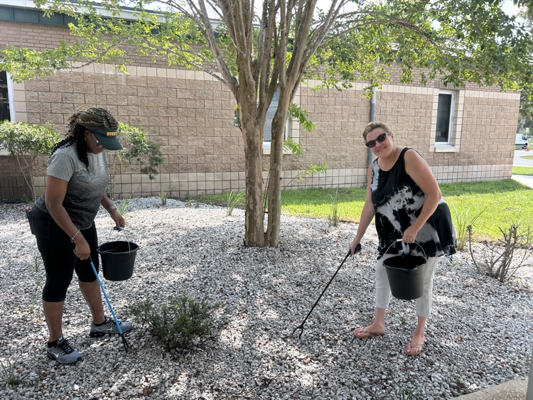 Teachers helping pick up trash during campus clean up
