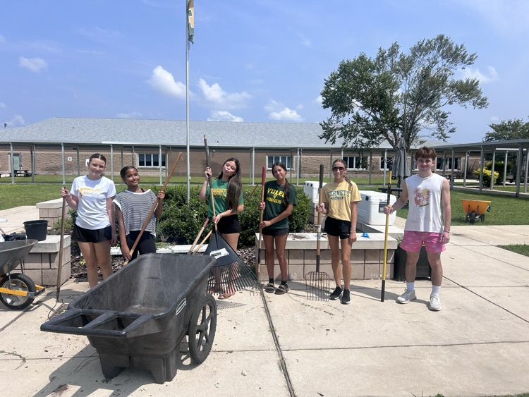 Cheerleaders doing yard work