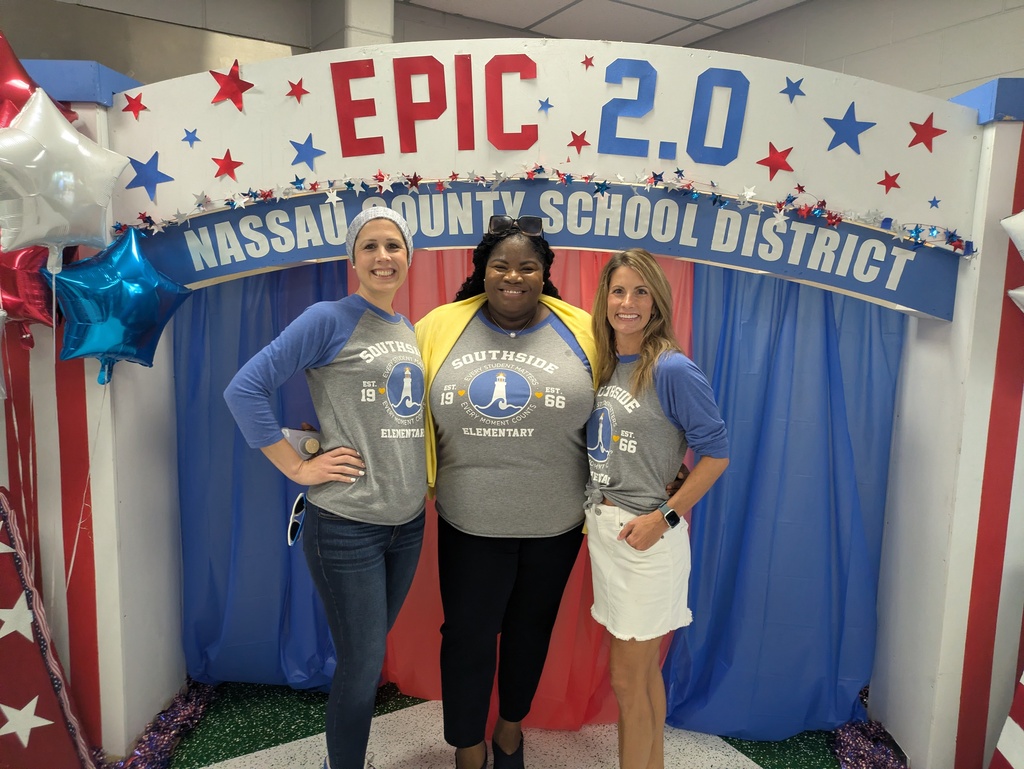 Three Southside Elementary staff members smile in front of a patriotic "EPIC 2.0 Nassau County School District" Convocation backdrop decorated with red, white, and blue stars and balloons while wearing matching Southside Elementary spirit shirts.
