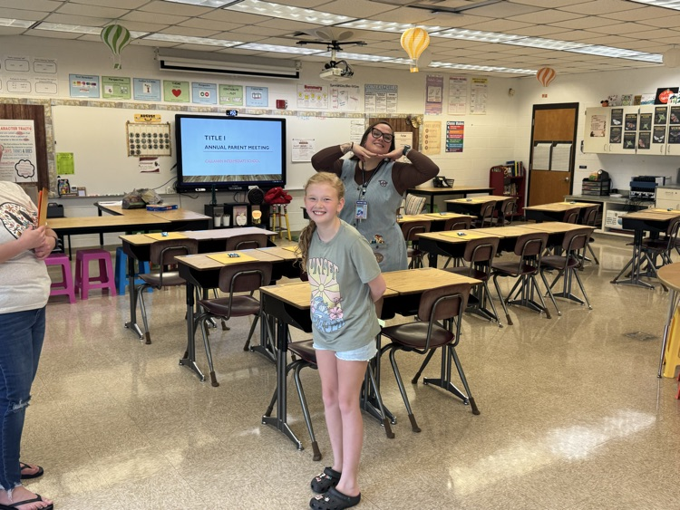 Ms. Hooper smiles and poses with a student during a back-to-school meet-and-greet in her classroom. 